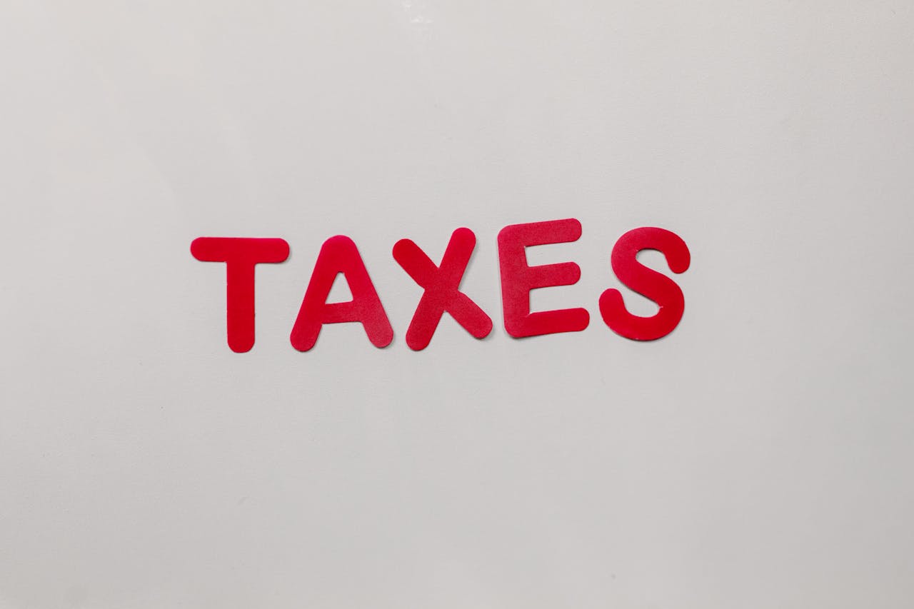 Simple and bold image of the word taxes in red letters on a white background.